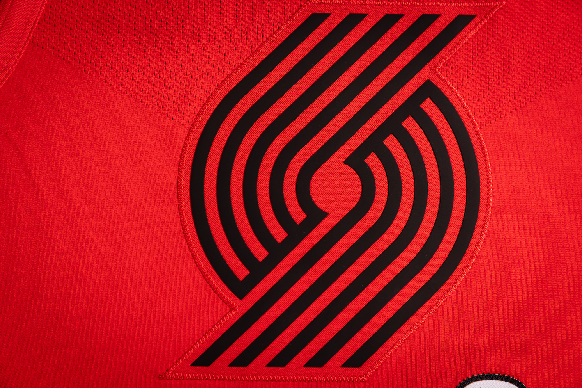Our primary “Pinwheel” logo represents teamwork and is prominently featured on the front of the jersey.